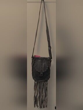 Women's Brown Fringe Leather Crossbody Bag with Magnetic Closure.